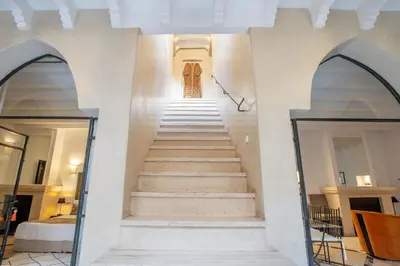 a staircase in a building with two arches at Riad & Spa Azzouz in Marrakech