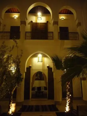 a building with two balconies and lights on it at Riad Matham in Marrakech