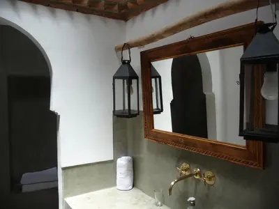 a bathroom with a mirror and a sink at Riad Matham in Marrakech