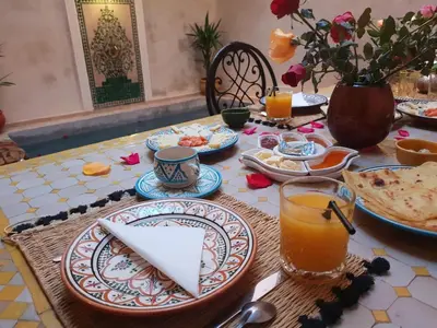 a table with plates of food and drinks on it at Dar Halima in Marrakech