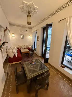 a living room with a couch and a table at Dar Fangui in Marrakech