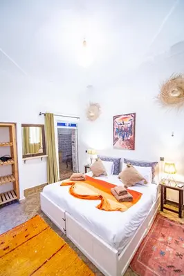 a bedroom with a large white bed in a room at KOUTOBIA ROYAL in Marrakech