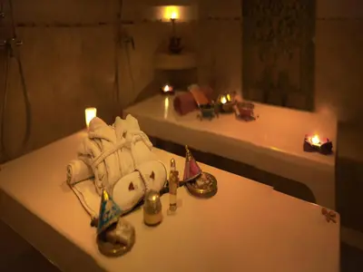 a bathroom with candles and towels on a table at Hotel Lawrence d'Arabie in Marrakech