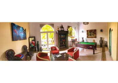 a living room filled with furniture and a pool table at Hotel Lawrence d'Arabie in Marrakech