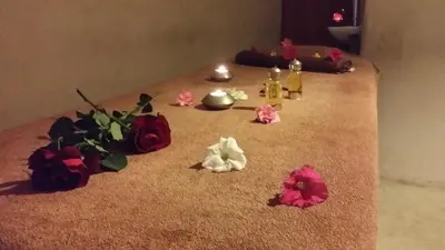a table with flowers and candles on the floor at Riad Al Ksar & Spa in Marrakech