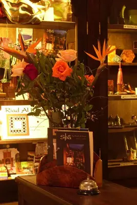 a vase with flowers on a table in a store at Riad Al Ksar & Spa in Marrakech