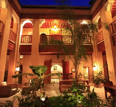 a lobby with a lot of plants in a building at Riad Al Ksar & Spa in Marrakech