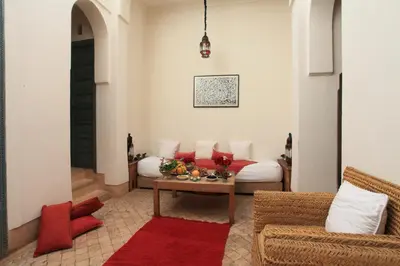 a living room with a couch and a table at Riad Dar Aicha en Exclusivité in Marrakech