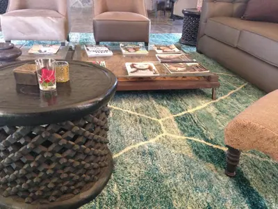 a living room with a coffee table and a couch at Hotel Les Cinq Djellabas in Douar Caïd Layadi