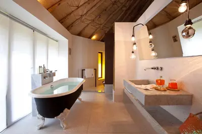 a large bathroom with a large tub and a sink at Hotel Les Cinq Djellabas in Douar Caïd Layadi