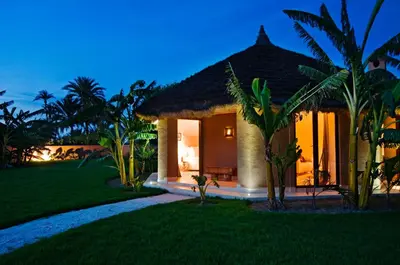 a villa with a garden and a resort at Hotel Les Cinq Djellabas in Douar Caïd Layadi