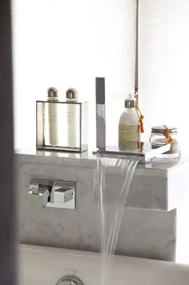 a sink with water coming out of it next to a mirror at Hotel Les Cinq Djellabas in Douar Caïd Layadi