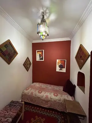 a bedroom with a bed and a chandelier at Riad N10 in Marrakech