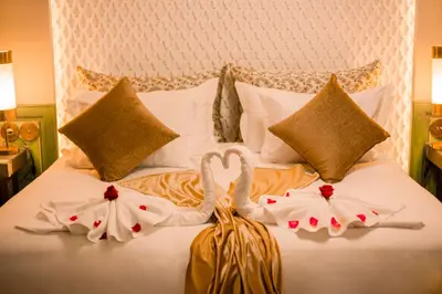 two swans made out of towels on a bed at Palais Dar Si Aissa ALL-SUITES in Marrakech
