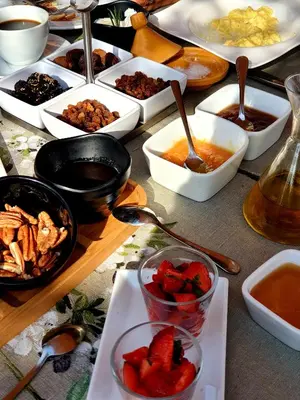 a table topped with bowls of food with strawberries and other dishes at Casa Taos in Marrakech