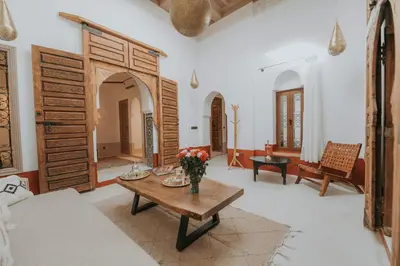 a living room with a vase of flowers on a table at Dar Akal in Marrakech