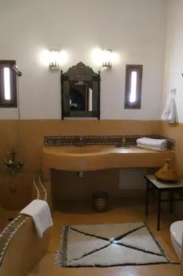 a bathroom with a large sink and a mirror at Riad Smara in Marrakech