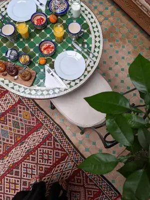 a table with plates of food on top of a rug at Riad Smara in Marrakech