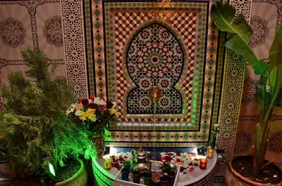 a room with plants and a wall with a mirror at Dar LEULEU in Marrakech