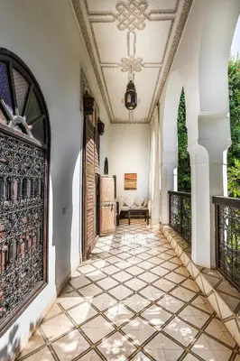a hallway of a house with a tiled floor at Riad Dar El Assafir in Marrakech