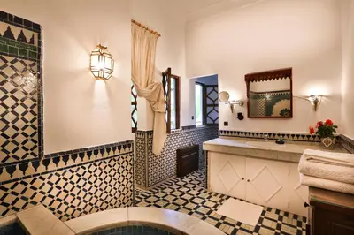 a bathroom with a sink and a mirror at Riad Dar El Assafir in Marrakech