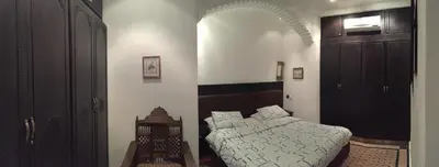 a bedroom with a bed and a table in it at Riad Dar El Assafir in Marrakech