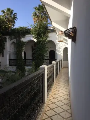 a hallway leading to a house with a fence at Riad Dar El Assafir in Marrakech