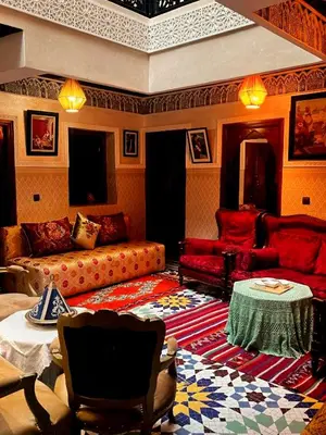 a living room with a couch and a table at Riad Lalla Marrakech in Marrakech