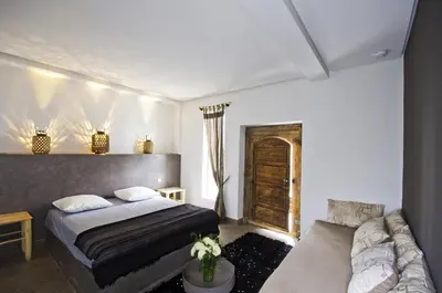 a bedroom with a bed and a couch at Riad Kasbah 117 in Marrakech
