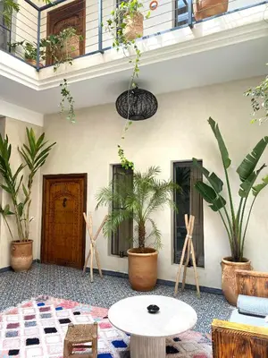 a room with potted plants and a table at Riad Kasbah 117 in Marrakech