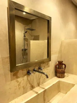 a bathroom sink with a mirror and a shower at Riad Kasbah 117 in Marrakech