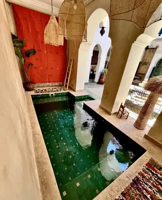 a room with a pool of water in a building at Riad Ecila in Marrakech