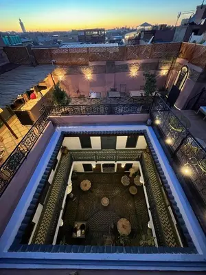 a view of a pool from a balcony with a table at Riad Ecila in Marrakech