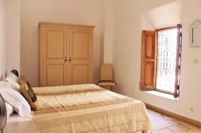 a bedroom with a bed and a window at Riad Miski in Marrakech