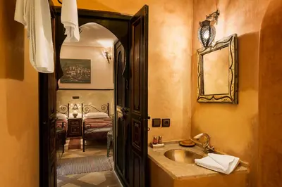 a bathroom with a sink and a mirror at Riad Julia in Marrakech