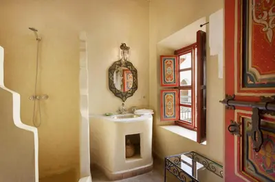 a bathroom with a sink and a mirror at Riad Julia in Marrakech