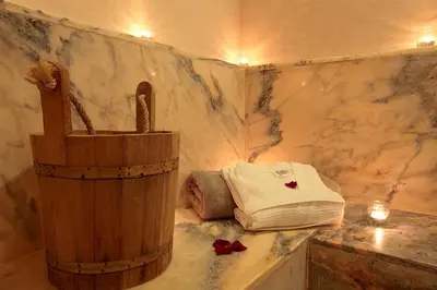 a small bathroom with a towel and a wooden barrel at Riad Monceau in Marrakech