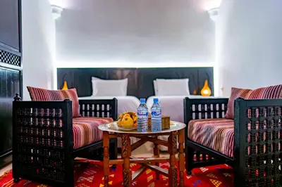 a hotel room with two chairs and a bed at Riad Dar Dialkoum in Marrakech