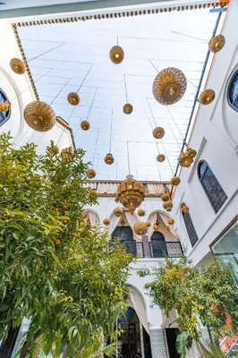 a building with gold balls hanging from the ceiling at Riad Dar Dialkoum in Marrakech