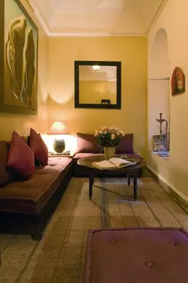 a living room with a couch and a table at Dar Attajmil in Marrakech