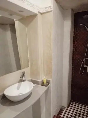 a bathroom with a white sink and a shower at Riad Swaka in Marrakech