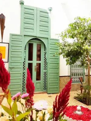 a green door of a house with flowers at Riad Swaka in Marrakech