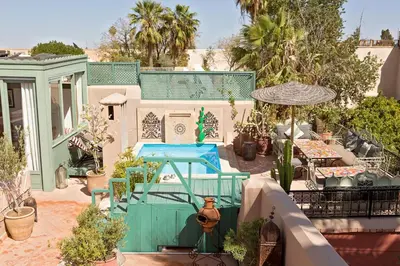 a house with a swimming pool in a yard at Riad Swaka in Marrakech