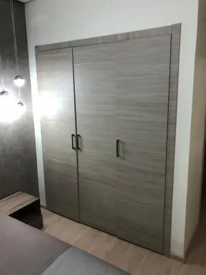 a large metal door in a room with a bed at Appartement à Prestigia Marrakeche avec jardin in Marrakech