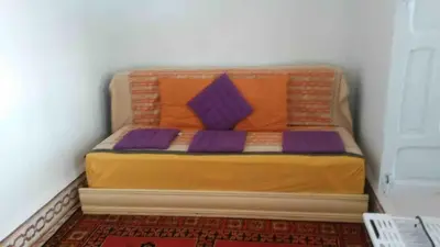 a small bed with purple pillows in a room at Riad Medina in Marrakech