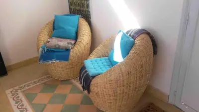 two wicker chairs with blue cushions sitting in a room at Riad Medina in Marrakech