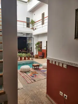 a hallway with a pool in a building at Riad la Parenthèse by Sashema in Marrakech