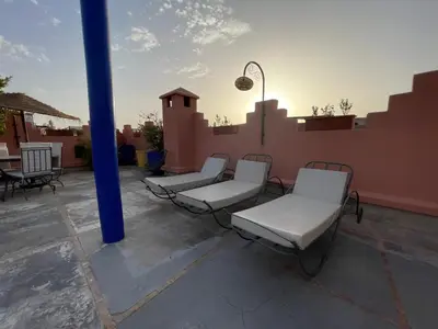 a group of chairs sitting on top of a roof at Riad Samarine in Marrakech