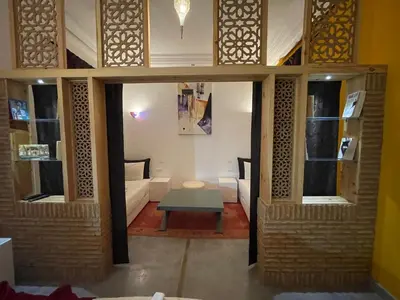 a living room with a table and a couch at Riad Samarine in Marrakech