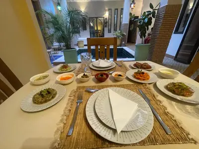 a table with plates of food on it at Riad Samarine in Marrakech